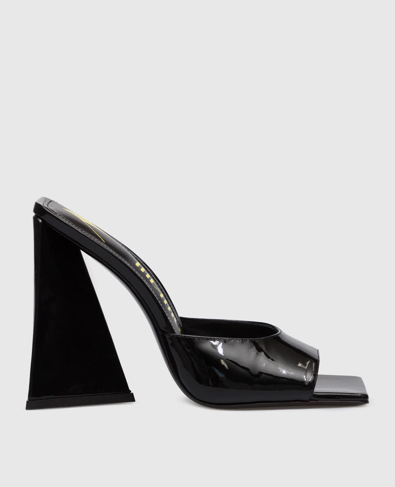 The Attico Devon mules in black patent leather with a figured heel